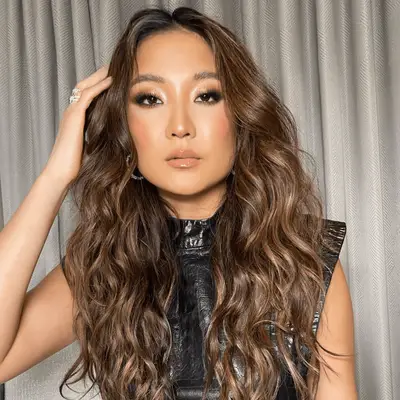 Ashley Park with light brown balayage.