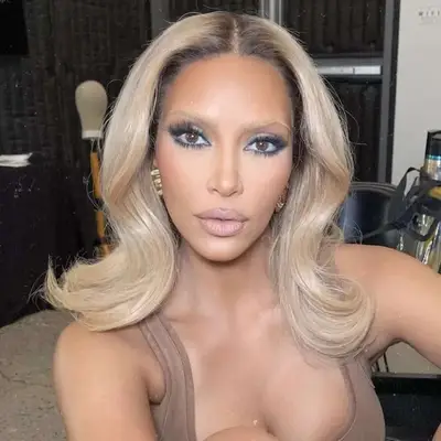 Kim Kardashian with 1970s-inspired blonde hair and dyed brows