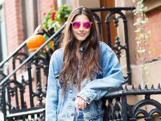 woman in sunglasses leaning against railing
