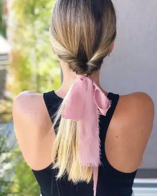 Twisted ponytail with frayed pink bow
