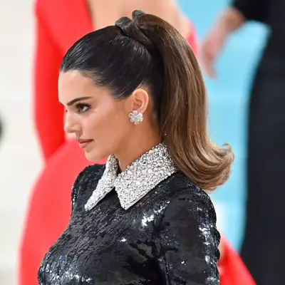 Kendall Jenner with retro flipped-out ponytail and sequin bodysuit at The 2023 Met Gala Celebrating 