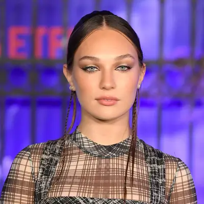 Maddie Ziegler with minimalist updo and face-framing braids at the world premiere of Netflix