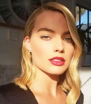 Margot Robbie wears a wavy long asymmetrical bob