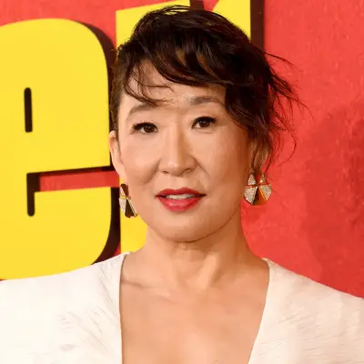 Sandra Oh with a wavy side bang updo hairstyle on the red carpet