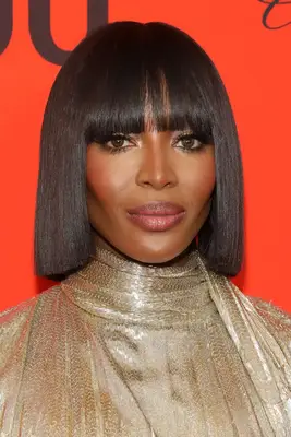Naomi Campbell with a blunt bob and bangs on the red carpet