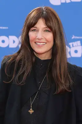 Catherine Keener with long brown hair and bangs on the red carpet
