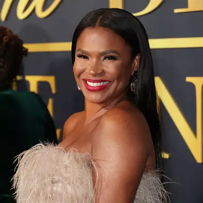 Nia Long with silky straight hair worn behind her ears on the red carpet