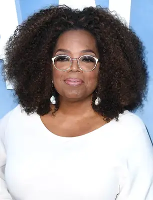 Oprah Winfrey with voluminous natural curls on the red carpet