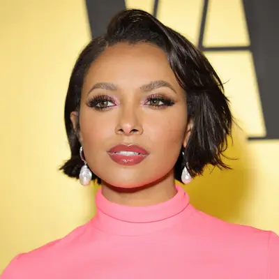 Kat Graham with a flipped French bob, shimmery pink eyeshadow, and glossy pink lipstick