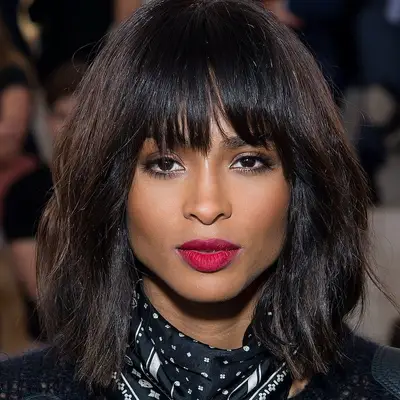 Ciara wears an A-line long bob haircut with tousled bangs and red lipstick