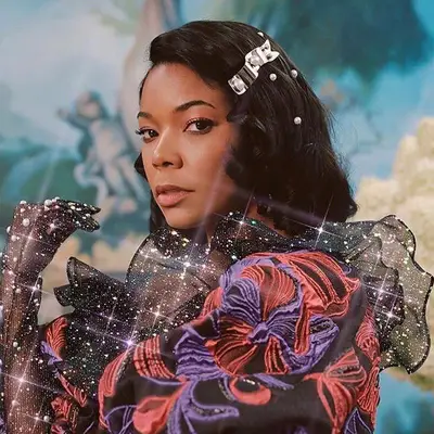 Gabrielle Union wears a voluminous A-line haircut with pearls and a silver barrette