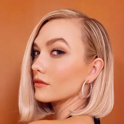 Karlie Kloss wears a sleek blonde blowout A-line haircut