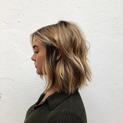 Side view of bronde wavy A-line long bob haircut