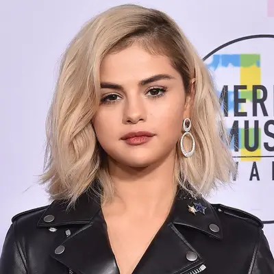 Selena Gomez wears a platinum blonde A-line bob haircut