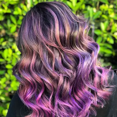 Back view of wavy hair with multi-toned purple balayage