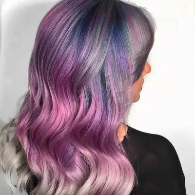 Back-side view of wavy hair with purple to silver ombre balayage
