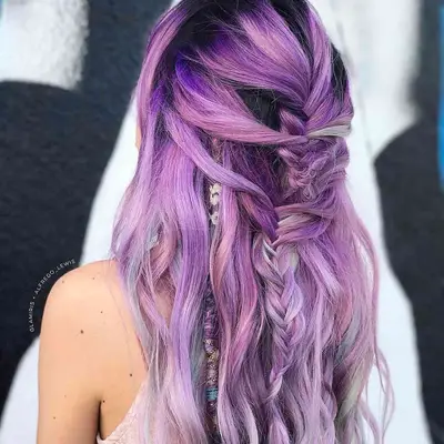 Back view of wavy hair with half-up braid, hair wrap, and purple to silver ombre balayage