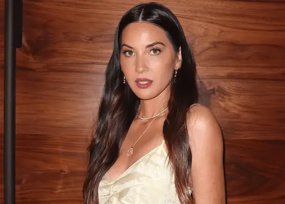 olivia munn posing for selfie with wavy brown hair