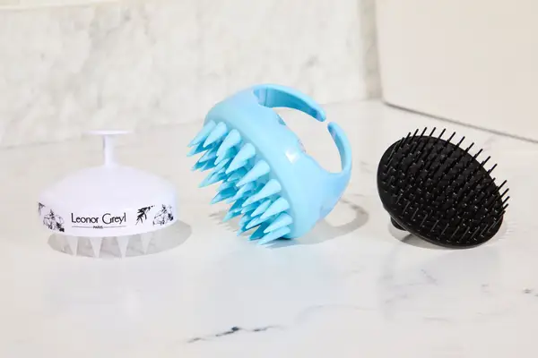 Scalp massagers on a white counter