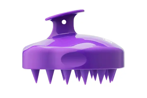 The Comfier Cordless Hair Scalp Massager sitting on a counter