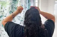 Person massaging top of head with Jupiter Scalp Brush 