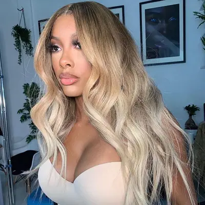 A woman with wavy gradient dark blonde hair