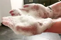 Hands full of shampoo lather