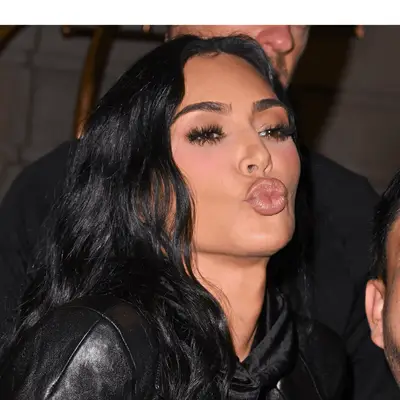 Kim Kardashian blowing a kiss with black hair