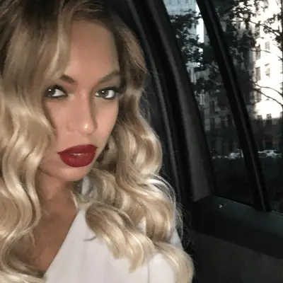 Joan Smalls wears long, straight brown hair with golden highlights