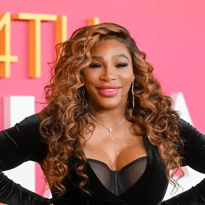 Anne Hathaway wears subtly highlighted brown hair with curtain bangs