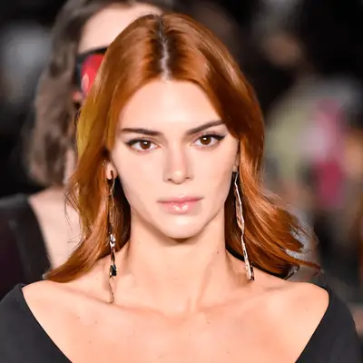 Emma Watson wears light auburn hair with side-swept bangs