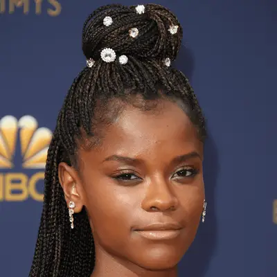 Letitia Wright wearing knotless braids with bedazzled bun
