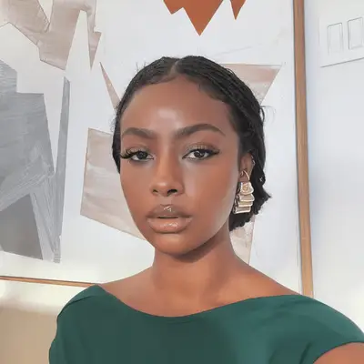 justine skye wearing knotless braids in a low bun