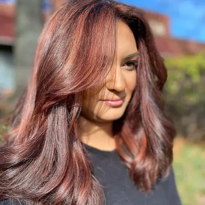 Woman with glossy strawberry brown hair