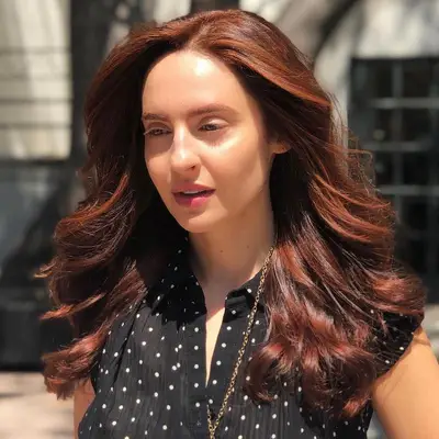Woman with warm strawberry brown hair