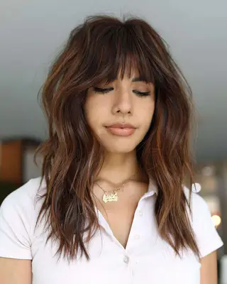 strawberry brown balayage with bangs