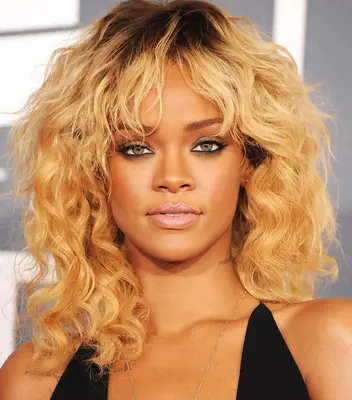 Rihanna with shoulder length curls with bangs