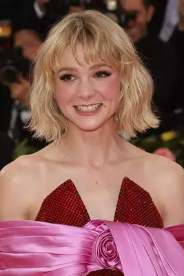 Carey Mulligan with messy blonde bob in red and pink bow dress