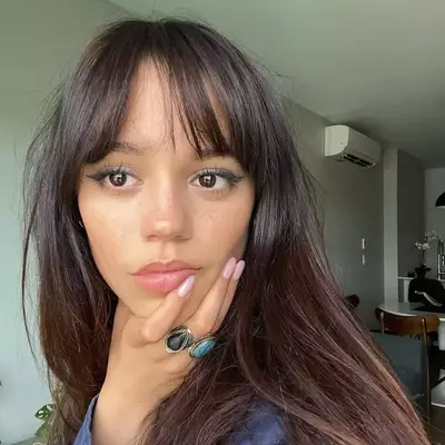 Jenna Ortega with Birkin Bangs and sleek blowout