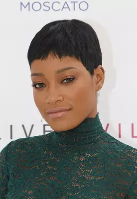 Keke Palmer pixie with baby bangs in emerald green lace dress