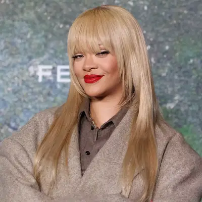Rihanna with wispy bangs and buttery blonde hair 