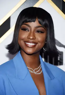 justine skye with stick straight bangs and flipped out bob in blue power suit