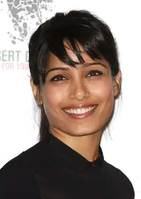 Freida Pinto with fringe and ponytail in black shirt