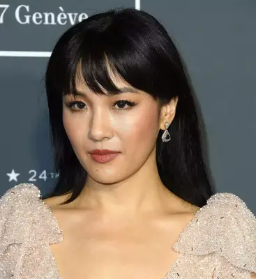 Constance Wu with lightweight bangs in champagne dress