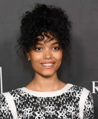 camila cabello in white off the shoulder top with fringe bangs and updo