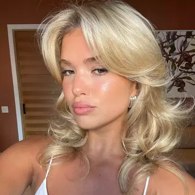 Matilda Djerf with a curly blonde hairstyle.