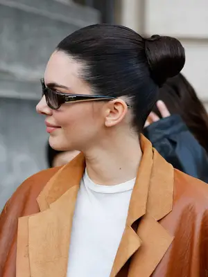 Kendall Jenner with black slicked back bun in middle of head