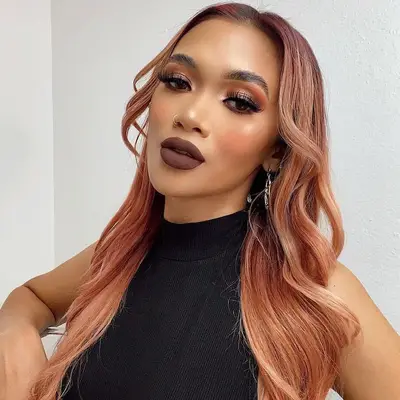 Woman with rose gold hair and eyeshadow look and dark brown lipstick