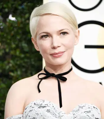 Michelle Williams wears a polished pixie cut with a deep side part