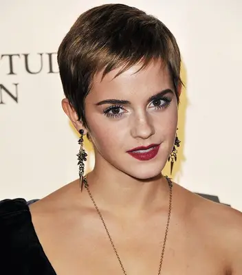 Emma Watson with a short, straight pixie cut with feathered bangs